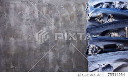 Denim jeans on old abstract background texture of table 75514934