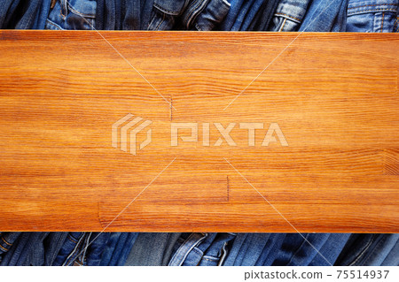 Denim jeans on old wooden background texture table surface Denim jeans on old wooden background texture table surface 75514937