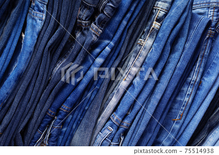 Stack or pile of denim jeans as background texture Stack or pile of denim jeans as background texture 75514938