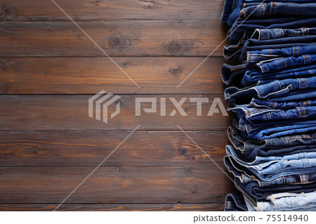Denim jeans on old wooden background texture table surface Denim jeans on old wooden background texture table surface 75514940