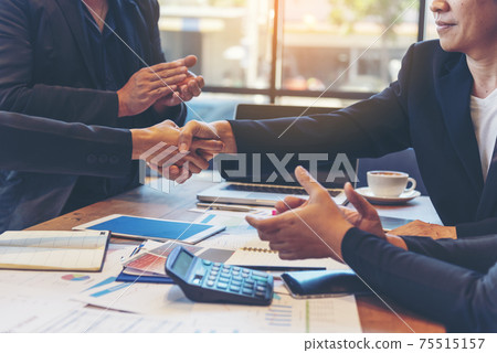 Team Business Partners shaking hands together to Greeting Start up small business in meeting room. Shakehand teamwork partners at modern office handshake together. Business mergers and acquisitions 75515157