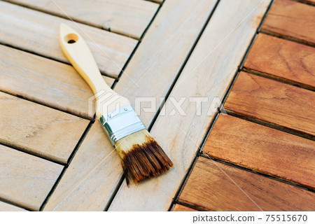 paintbrush on a renewable exotic wooden garden table - for background paintbrush on a renewable exotic wooden garden table - for background 75515670