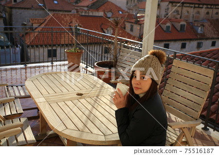 girl have coffee on the balcony girl have coffee on the balcony 75516187