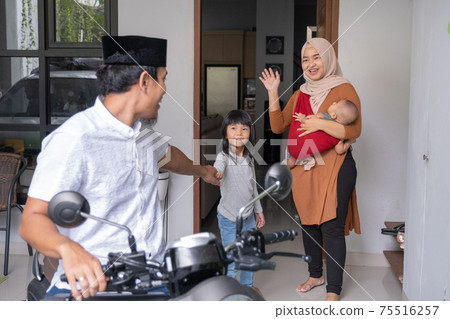 muslim man going by motorcycle scooter leaving his family behind at home muslim man going by motorcycle scooter leaving his family behind at home 75516257