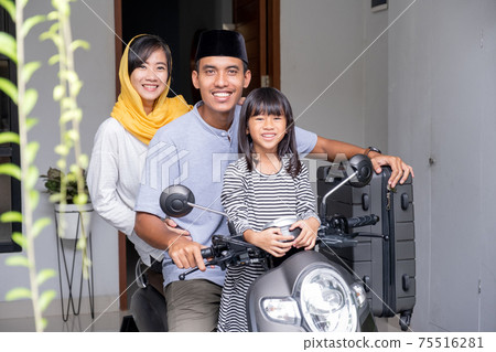 asian muslim family riding motorbike scooter together traveling with kid 75516281