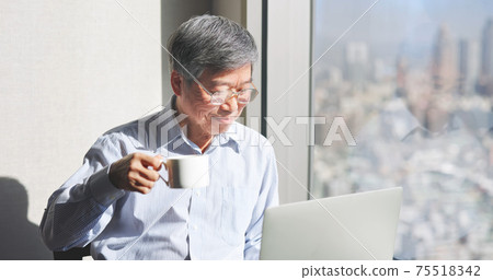 man use laptop near window 75518342