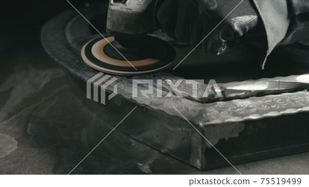 Forge workshop. Smithy manual production. Polish metal with an angle grinder with an abrasive nozzle. Polishing iron. Forge workshop. Smithy manual production. Polish metal with an angle grinder with an abrasive nozzle. Polishing iron. 75519499