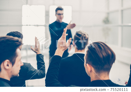 rear view. employees ask questions at a business briefing rear view. employees ask questions at a business briefing 75520111