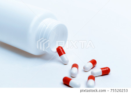medicine bottle and capsules on a white background. 75520253