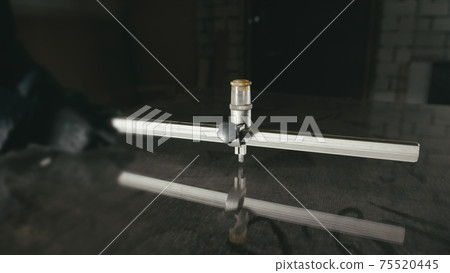 Glass cutting and processing for fireplace doors. Circular glass cutter. Worker cut glass with glass cutting diamond. 75520445