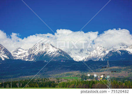 high tatra mountain ridge in springtime. cloud above the snow capped rocky peaks. beautiful sunny weather. wonderful nature scenery 75520482