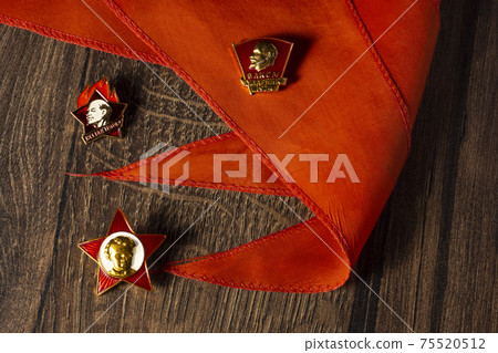 Badges of Soviet pioneers and komsomol with a portrait of Lenin on pioneer tie Badges of Soviet pioneers and komsomol with a portrait of Lenin on pioneer tie 75520512