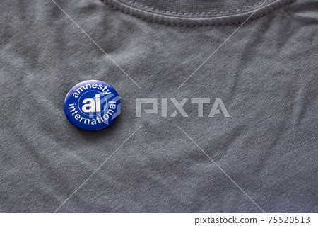 Badge of Amnesty International, human rights organization on shirt Badge of Amnesty International, human rights organization on shirt 75520513