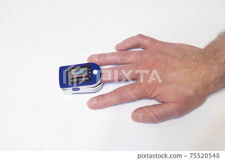 Pulse oximeter on finger measures pulse rate and hemoglobin oxygen saturation 75520548