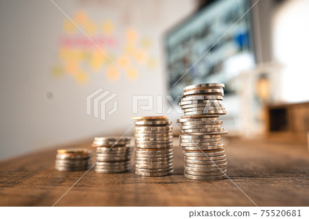 Money coin Grow up business and computer Concept,Silver coins stacked on wooden desks. Money coin Grow up business and computer Concept,Silver coins stacked on wooden desks. 75520681