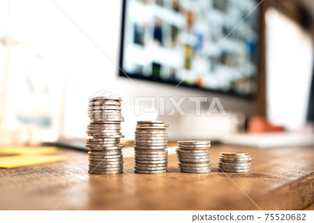 Money coin Grow up business and computer Concept,Silver coins stacked on wooden desks. 75520682