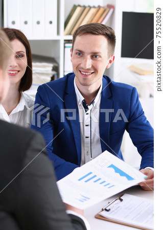 Group of people sit in office deliberate on problem 75520829