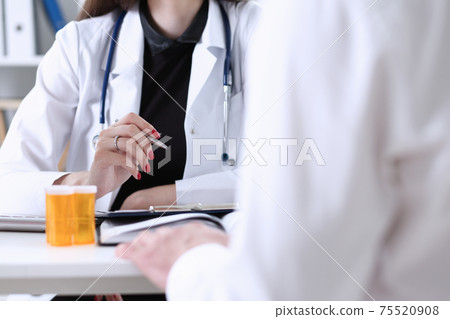 Female doctor hand hold silver pen 75520908