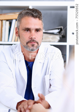 Friendly male doctor hold female arm in office Friendly male doctor hold female arm in office 75520932