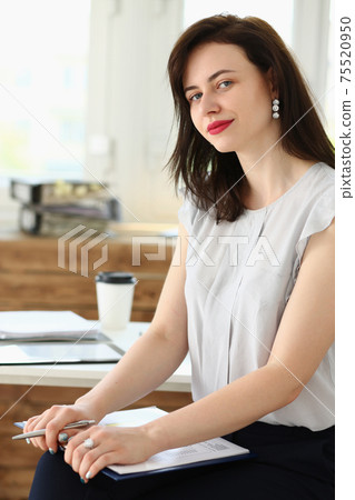 Beautiful smiling businesswoman portrait at workplace 75520950