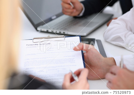 Male arm in suit offer contract form on clipboard pad 75520973