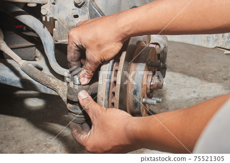 Car Mechanic or Auto Mechanic Tighten Castle Nut or Crown Nut Car Mechanic or Auto Mechanic Tighten Castle Nut or Crown Nut 75521305