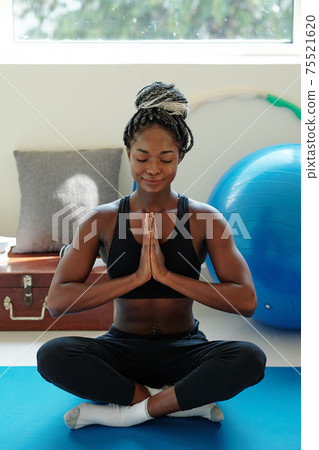 Woman meditating at home 75521620