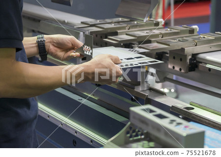 The technician operator working with press brake hydraulic bending machine.  75521678