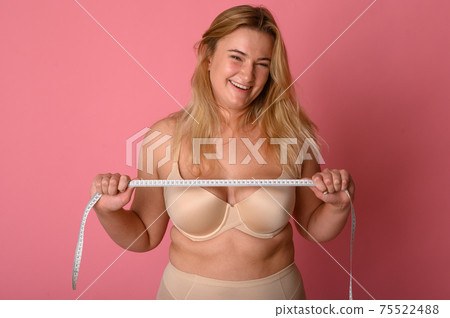 attractive fat girl with measuring tape on pink background attractive fat girl with measuring tape on pink background 75522488