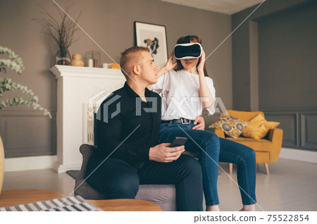 young couple spend time together playing VR in living room young couple spend time together playing VR in living room 75522854