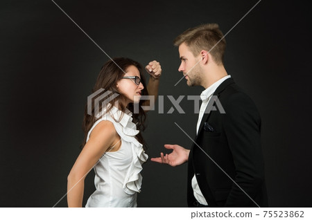 Angry professional woman clench fist at male coworker Angry professional woman clench fist at male coworker 75523862