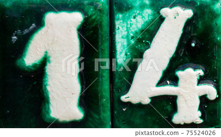 Decorative ceramic house number 14 tile on the wall, characteristic decorative element Decorative ceramic house number 14 tile on the wall, characteristic decorative element 75524026