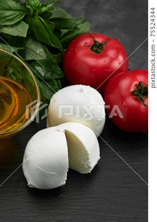 Fresh handmade soft Italian cheese from Campania, white balls of buffalo mozzarella cheese made from cow milk ready to eat close up 75524344