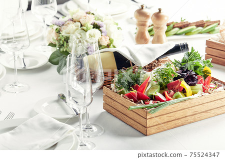 chopped fresh vegetables in a wooden box on a white background. Banquet festive dishes. Gourmet restaurant menu. chopped fresh vegetables in a wooden box on a white background. Banquet festive dishes. Gourmet restaurant menu. 75524347