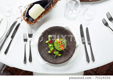Salad of avokado, seafood, meat, vegetables and pumpkin seeds. Dietary, wholesome and tasty. Banquet festive dishes. Gourmet restaurant menu. White background. Salad of avokado, seafood, meat, vegetables and pumpkin seeds. Dietary, wholesome and tasty. Banquet festive dishes. Gourmet restaurant menu. White background. 75524350