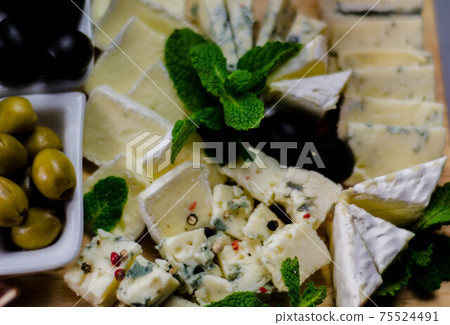 set of different cheeses on a wooden board, cheese board, delicious snack, healthy and exclusive food set of different cheeses on a wooden board, cheese board, delicious snack, healthy and exclusive food 75524491