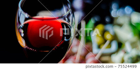 Red wine and set of different cheeses on a wooden board, delicious snack 75524499