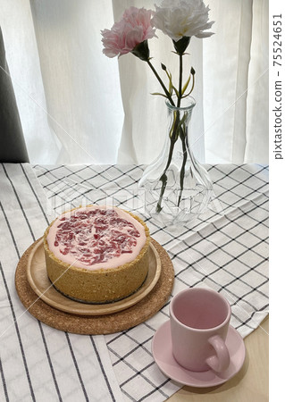 Yogurt strawberry cheesecake decorate with empty pink coffee shot cup and rose flowers. 75524651