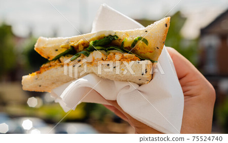 chicken breast in tikka spices, served with onion bhaji, crisp spinach and crunchy cucumber, all in sandwich 75524740