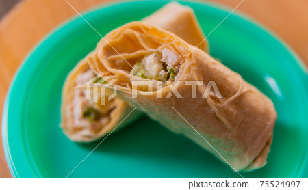 Chicken breast with caesar dressing and lettuce in a gluten-free tortilla wrap 75524997