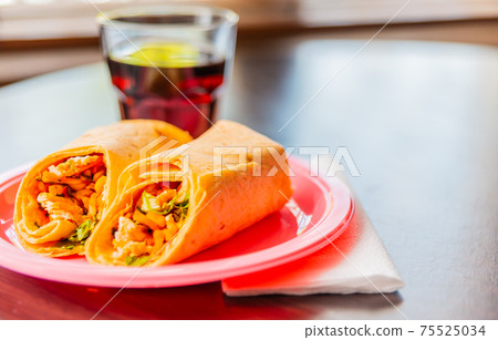 Chicken breast with piri piri sauce and lettuce in a chili tortilla wrap Chicken breast with piri piri sauce and lettuce in a chili tortilla wrap 75525034