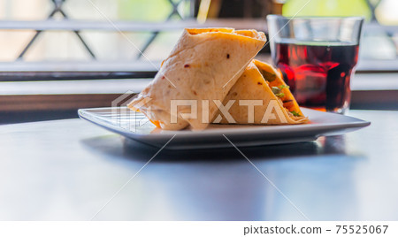 Chicken breast with piri piri sauce and lettuce in a chili tortilla wrap 75525067