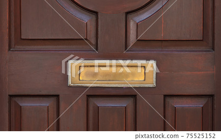 Old letterbox in the door, traditional way of delivering letters to the house, old mailbox 75525152