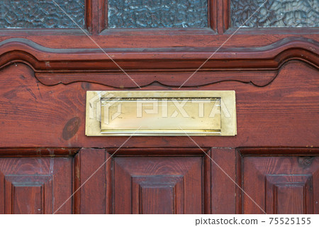 Old letterbox in the door, traditional way of delivering letters to the house, old mailbox 75525155