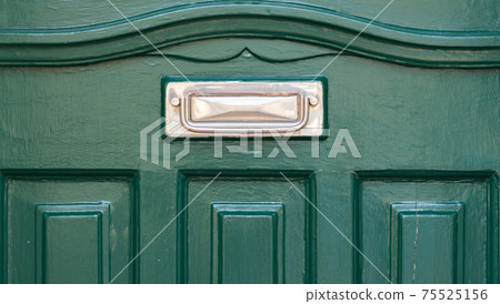 Old letterbox in the door, traditional way of delivering letters to the house, old mailbox Old letterbox in the door, traditional way of delivering letters to the house, old mailbox 75525156