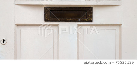Old letterbox in the door, traditional way of delivering letters to the house, old mailbox Old letterbox in the door, traditional way of delivering letters to the house, old mailbox 75525159