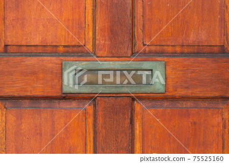 Old letterbox in the door, traditional way of delivering letters to the house, old mailbox Old letterbox in the door, traditional way of delivering letters to the house, old mailbox 75525160