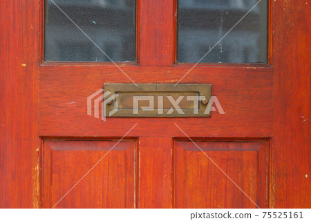 Old letterbox in the door, traditional way of delivering letters to the house, old mailbox Old letterbox in the door, traditional way of delivering letters to the house, old mailbox 75525161