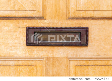 Old letterbox in the door, traditional way of delivering letters to the house, old mailbox Old letterbox in the door, traditional way of delivering letters to the house, old mailbox 75525162
