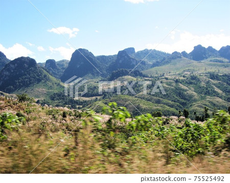 Car window from Vang Vieng, Laos to Luang Prabang (Luang Prabang). Car window from Vang Vieng, Laos to Luang Prabang (Luang Prabang). 75525492